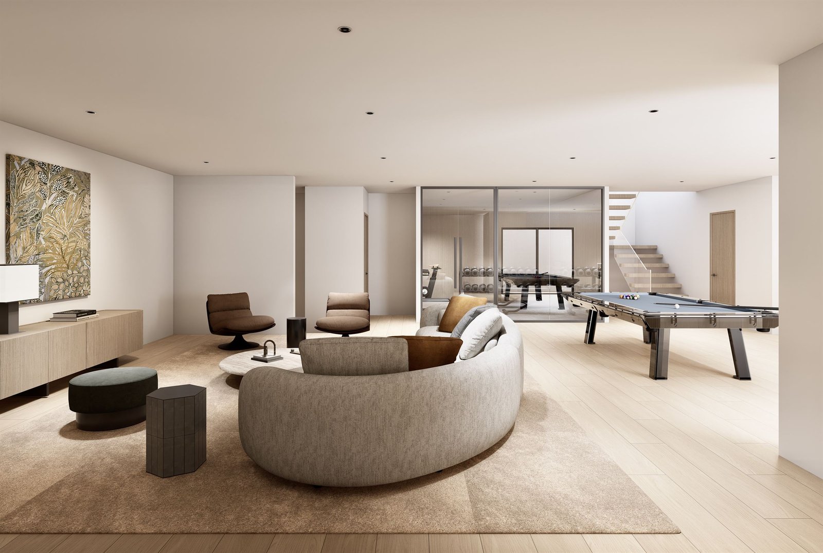 Lower-level recreation room with a curved sofa, a billiards table and a stair beyond