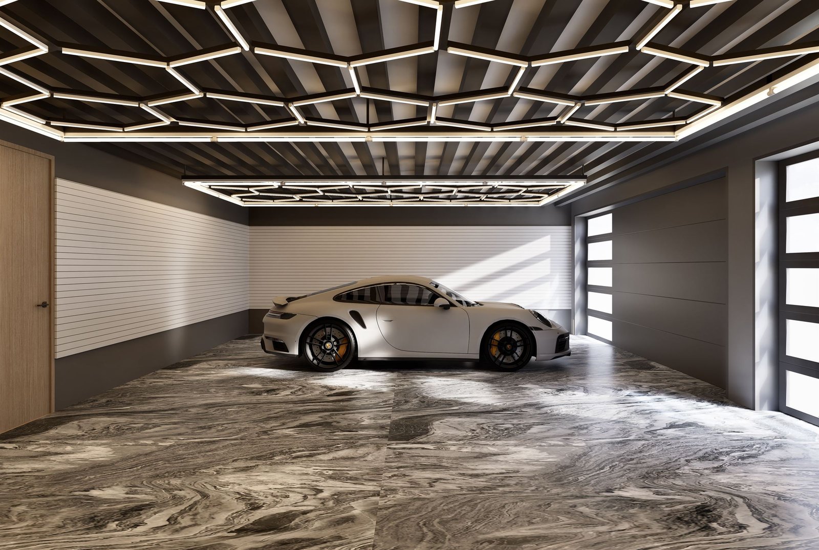 Wide view of the garage showing the full lighting grid and storage wall